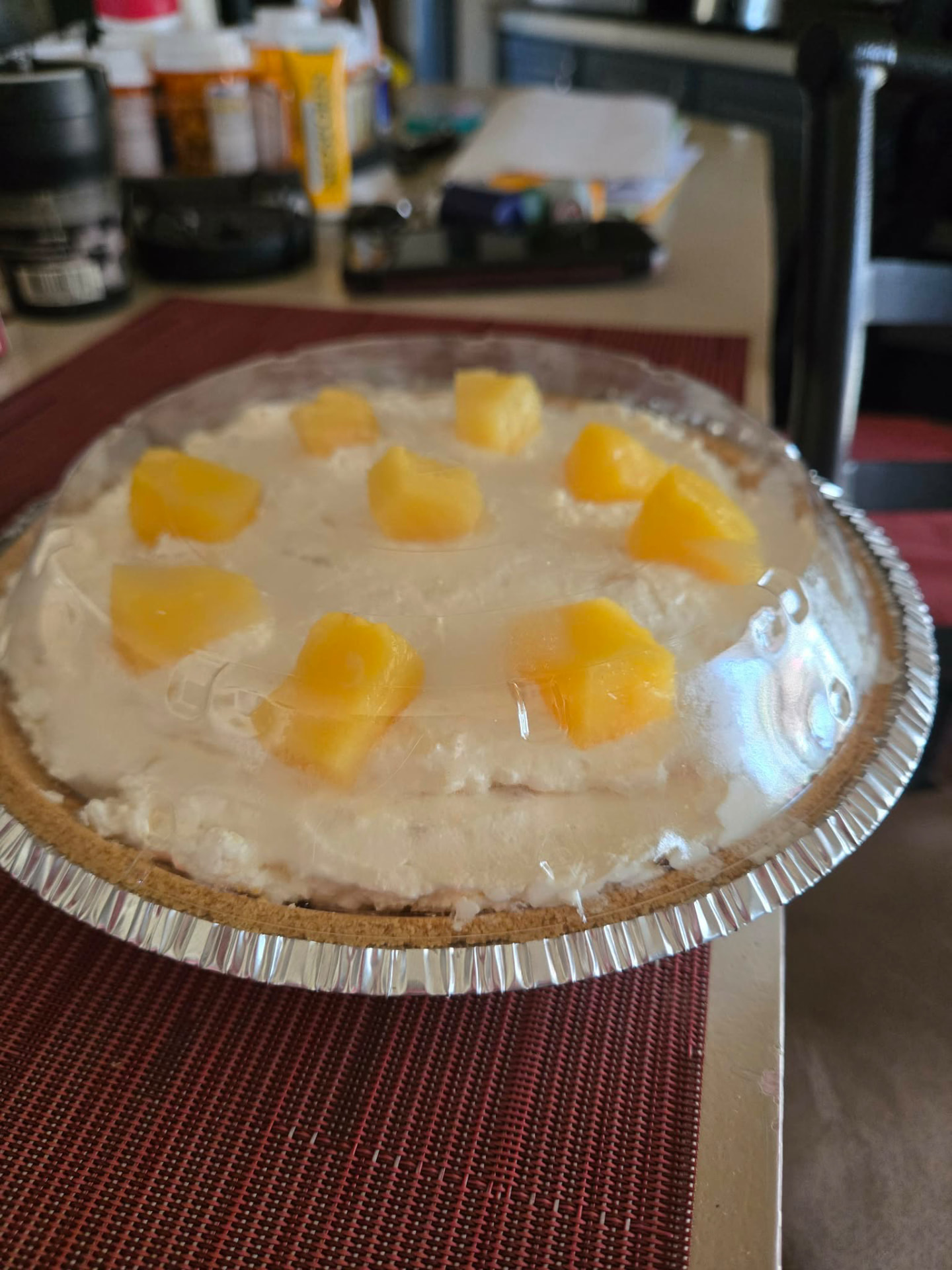 Creamy pineapple dream pie in a graham crust topped with pineapple chunks